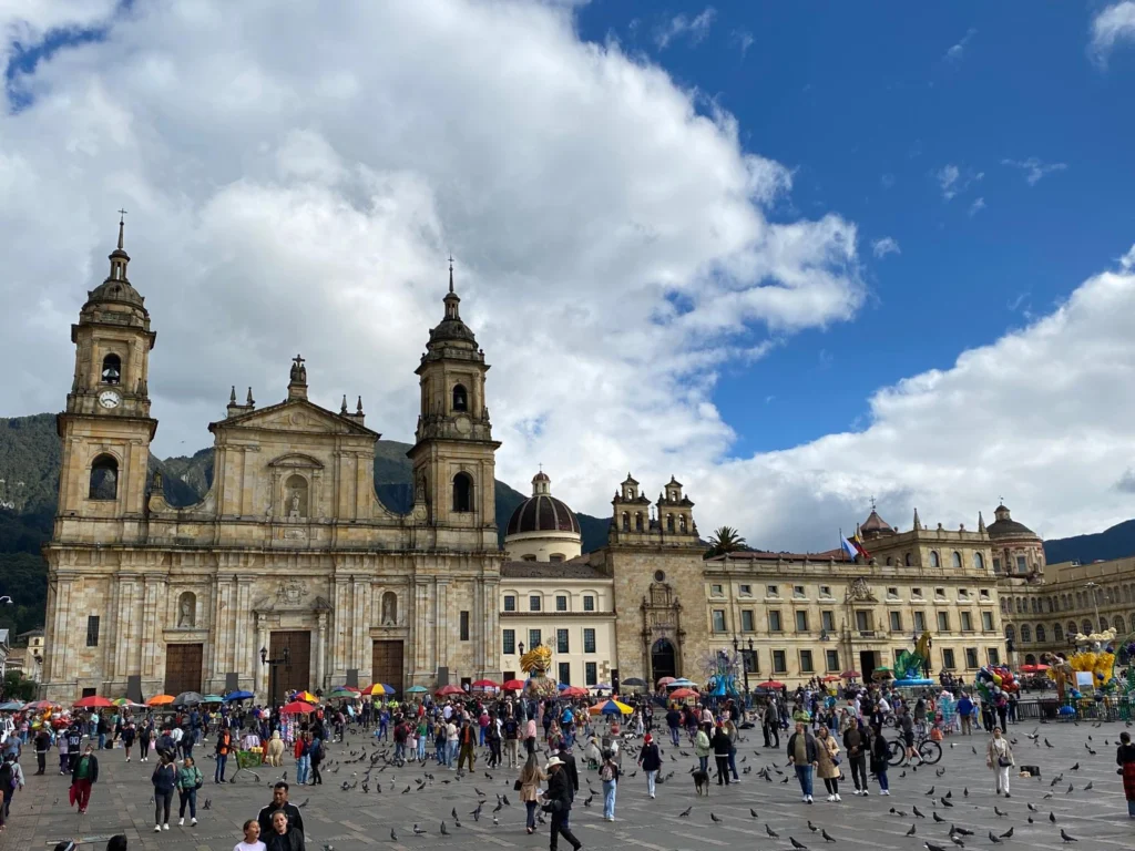 Tourists gathered near a historic building in Colombia — one of the best cheapest places to travel in South America.