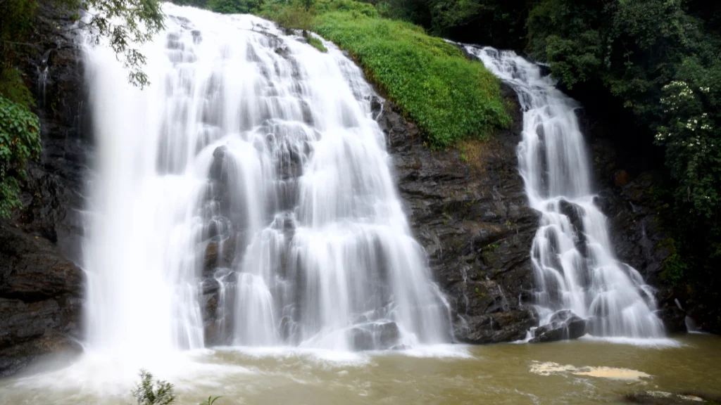 Abbey Falls cascading through lush green forest in Coorg — best places to visit in summer in India for nature and waterfall lovers.