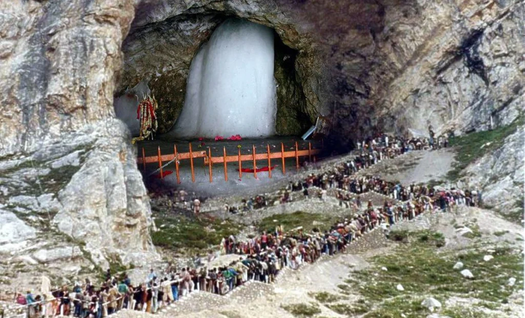 Amarnath Yatra (places to visit in Kashmir), pilgrims trekking through snow-covered mountains toward the sacred Amarnath Cave Shrine.