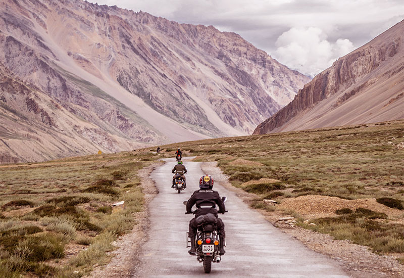 Bike or SUV on Spiti Valley’s rugged mountain road — best places to visit in summer in India for self-drive adventure and road trips.