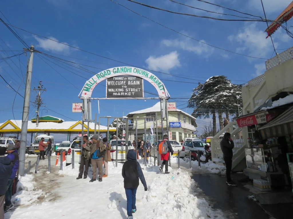 Gandhi Chowk square with shops and tourists in Dalhousie — best places to visit in summer in India for local shopping and hill vibes.
