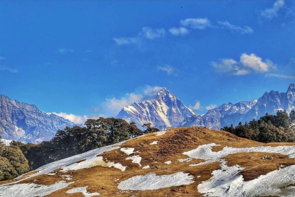 Auli’s green meadows with snow-capped Himalayan peaks — best places to visit in summer in India for nature and mountain views.