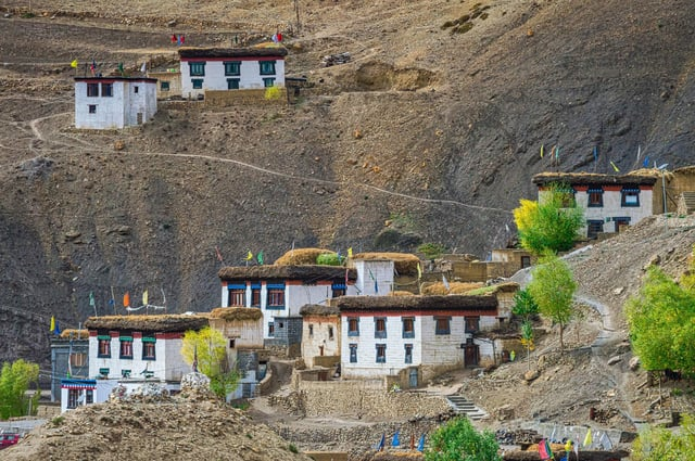 Mud-brick house in Spiti Valley with mountains in the background — best places to visit in summer in India for traditional Himalayan living.