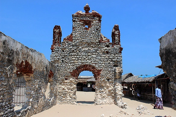 Abandoned buildings and a long stretch of sand in Dhanushkodi — a mysterious coastal town and one of the best places in India to travel solo.