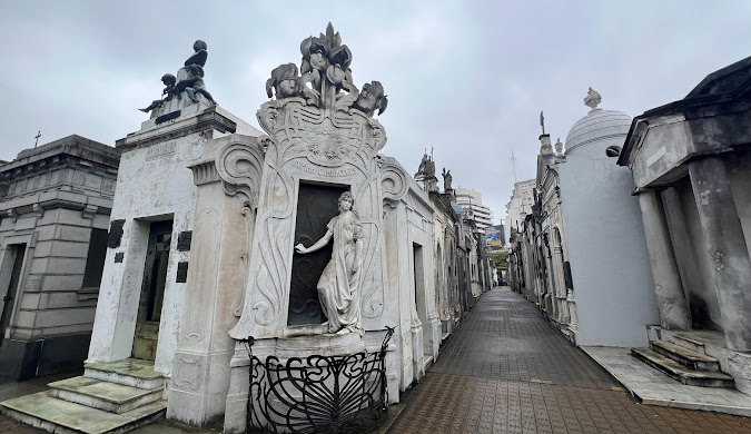 Statue on a wall in Recoleta Cemetery, Argentina — a unique spot in the best cheapest place to travel in South America.
