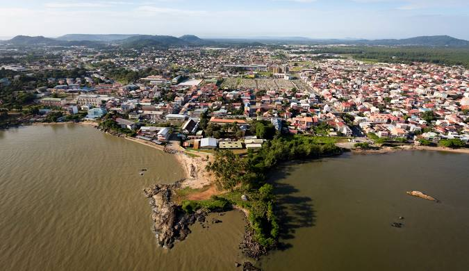 Tropical jungle and colonial buildings in French Guiana — an offbeat gem and one of the best cheapest places to travel in South America.